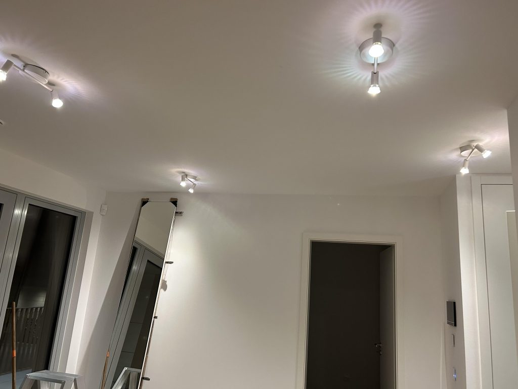 Ceiling view of a modern room with multiple LED spotlight fixtures professionally installed, providing warm and focused lighting throughout the space.